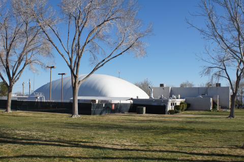 An outdoor photograph of the Swimming and Racquetball complex on a beautiful day with blue skies.