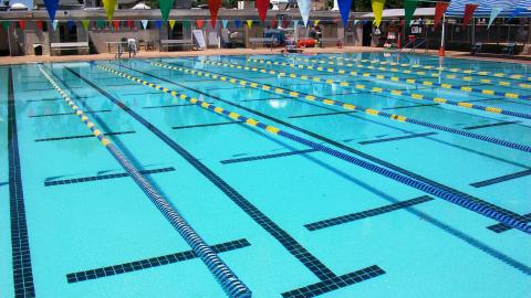 The still waters show off the open lanes of the Boulder City Swim Pool, before visitors arrive.