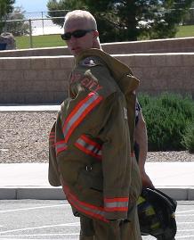 A fireman carrying his uniform coat