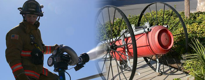 A fireman operating a hose apparatus and an antique fire hose apparatus